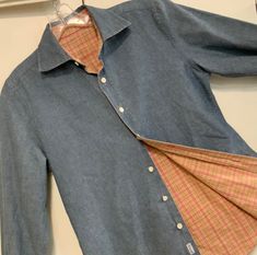 "This is a preppy, vintage (age unknown), woman's size (chest 39 inches), reversible shirt.  Unusual in that it buttons on the mens side when it definitely is a woman's shirt.  It has the \"Faconnable\" label in the lower-front placard, however because it is a reversible blouse there are no other labels to be seen.  It is known to be designed in France, but made in Hong Kong by designer Albert Goldberg.  As far as sizing you will need to go by the measurements listed below this text.  It is a classically-styled blouse featuring a light-blue, chambray cotton on one side and a small-scale, pink plaid on the reverse side.  There is some weight to the fabric because it is double thickness.  This unusual blouse features a collar, long button-cuff sleeves, back yoke, fitted princess seaming in t Preppy Vintage, Denim Blouse, Chambray Shirt, Blouse Shirt, Pink Plaid, Cuff Sleeves, Classic Shirt, Chambray, Womens Clothing Tops