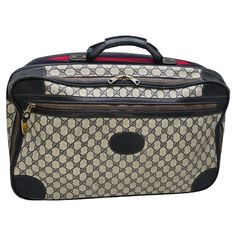 Experience luxury and sophistication while traveling with this vintage Gucci GG Suitcase. Crafted from the iconic GG canvas and navy leather trim, this vintage suitcase exudes elegance. With two spacious compartments and tie straps, this Italian-made suitcase keeps your belongings organized in style, while the iconic navy and red striped web textile and gold-tone hardware adds a touch of opulence. Designer: Gucci Material: GG Web canvas and navy Leather trim Origin: Italy Serial Code: 067 Circa: 70's Measurements: 20.75”W x 13.5”H x 7.75”D Handle Drop: 2” Closure/Opening: Two way Zip Interior Lining: Textile fabric Hardware: Brass Overall Condition: Good pre-loved vintage condition with wear consistent with age and use; moderate residue throughout interior, moderate wear throughout base, c Gucci Vintage, Vintage Suitcase, Bag Suitcase, Navy Leather, Textile Fabrics, Leather Trim, Fashion Handbags, Vintage Gucci, Leather Trims