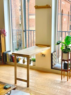 an empty room with a table and chairs in front of large windows overlooking the city