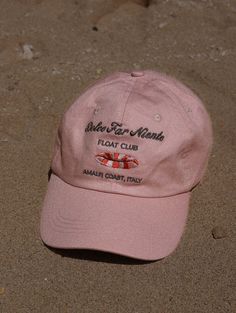 Inspired by the Dolce Far Niente lifestyle. Floating under the stunning Positano coastline, soaking up the art of doing nothing. Light pink cap, embroidery in taupe & orange, with a luxe satin interior lining. Pink Dad Hat With Curved Visor For Summer, Pink Curved Visor Dad Hat For Summer, Beach Baseball Cap With Embroidered Logo, Beach Dad Hat With Embroidered Logo, Pink Baseball Cap For Beach With Curved Bill, Casual Beach Baseball Cap With Embroidered Logo, Pink Dad Hat With Embroidered Logo, Embroidered Logo Beach Visor Hat, Beach Visor Hat With Embroidered Logo