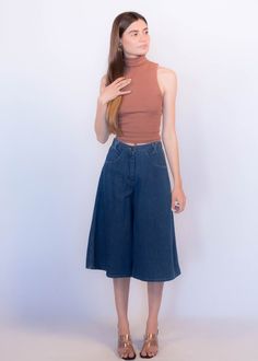 "Vintage 70s boho denim culottes. These great culottes are trending this season and are just perfect for summer style! High-waist fit. X criss-cross belt loops. Front pockets. Back western yoke detail. Wide-leg silhouette. Front button and zipper fastening. Unlined. Cut from 100% cotton. We kindly ask that you please view all measurements for comparison so you can get your desired fit. * Brand: n/a * Decade: 1970s * Fabric: 100% Cotton * Lining: Unlined * Color: Medium Dark Wash C O N D I T I O 70s Inspired Wide Leg Jeans For Spring, 70s Inspired Denim Bottoms, Trendy Wide Leg Summer Culottes, 70s Inspired High Waist Bottoms For Spring, 70s Inspired Denim Jeans For Spring, 70s Inspired High Rise Jeans For Spring, 70s Inspired Spring Denim Jeans, Summer Cropped Leg Medium Wash Flare Jeans, Summer Cropped Leg Flare Jeans In Medium Wash