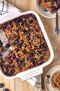 blueberry baked oatmeal in a white baking dish on a wooden table