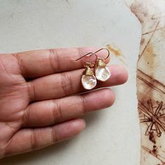 "Made to order. The first five pictures are in gold filled. The sixth and seventh are in sterling silver, are the eighth and ninth are in rose gold. The last picture shows all three styles. ~ pale peach keishi pearls, peach moonstone ~ gold filled, sterling silver, or rose gold filled wire and ear wires ~ approximately 1 1/4 inches (3.2 cm), from the top of the ear wire to the bottom of the pearl ~ POSTS: Sterling silver, gold filled, or rose gold filled posts are also available. Send me a messa Handmade Briolette Earrings For Anniversary, Wire Wrapped Rose Gold Earrings For Gift, Handmade Gold Briolette Pearl Earrings, Handmade Briolette Pearl Earrings For Gift, Gold Wire Wrapped Pearl Earrings For Gift, Dainty Wire-wrapped Pearl Earrings For Gift, Dainty Wire Wrapped Pearl Earrings For Gift, Rose Gold Teardrop Pearl Earrings As Gift, Handmade Rose Gold Earrings For Everyday