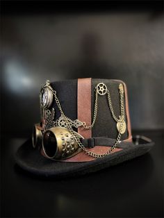 Our brown/black steampunk hat with goggles radiates sophistication, join the steampunk revolution and claim your spot among the fashion-forward. Perfect for themed events, cosplay, or adding a dash of steampunk to your everyday attire.


Age Group/Gender - Adult/Unisex

Size/Type - One size fits all adults
Color - Brown/Black Luxury Steampunk Hat With Short Brim, Luxury Adjustable Steampunk Hat, Steampunk Horn Hat, Vintage Hat Costume Accessories For Cosplay, Vintage Hat For Cosplay, Steampunk Brimmed Halloween Costume Hat, Vintage Top Hat With High Crown For Cosplay, Vintage High Crown Top Hat For Cosplay, Vintage Brimmed Costume Accessories