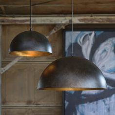 two lamps hanging from the ceiling in a room