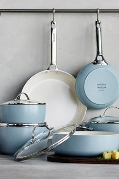 several pots and pans are hanging on the wall