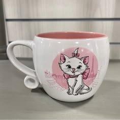 a coffee cup with a cat on it