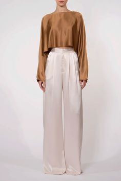 The Paris Pant from Nonchalant Label is crafted from luxuriously soft 100% polyester, featuring a high-waisted, wide-leg silhouette with pleats and a classic front zipper closure. Perfect for elevating your wardrobe, this pant provides an elegant, sophisticated look without compromising on comfort. Made in China Composition: 77% Triacetate, 23% Polyester Satin Pants Outfit, Gold Blouse, Satin Pants, Silk Pants, Satin Top, Pants Outfit, Look Fashion, Trousers Women, Front Zipper