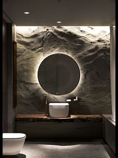 a bathroom with a round mirror on the wall