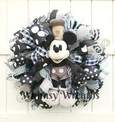 a mickey mouse wreath hanging on the front door