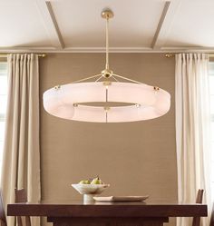 a dining room table with two chairs and a chandelier hanging from the ceiling