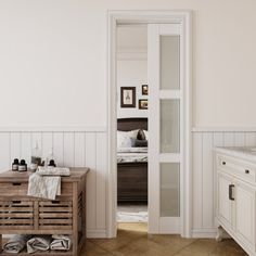 a bathroom with white walls and wood floors