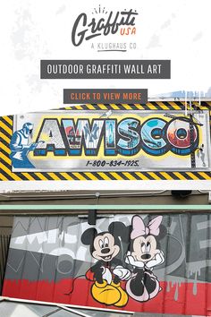 an advertisement on the side of a building with mickey and minnie mouses painted on it