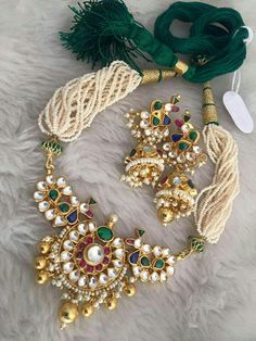 *It Is Handmade Gold Plated Indian Kundan Jewelry Necklace and Earrings Set. *It is 22 K Gold Plated necklace made from Silver and Copper-Mix material and also using handcut stones. *It is a beautiful Ethnic Indian Wedding Choker with Statement Earrings. *Its Earrings are 2.5 Inches Long. *Necklace and Earrings are same as in picture. *It will come with adjustable string which fits all Neck size. *Our all jewelry is made from semiprecious stones and beads. *WARRANTY: ITS GENUINE HANDMADE JEWELRY Multicolor Jeweled Earrings For Wedding, White Jewelry With Latkans For Celebration, Celebration White Jewelry With Latkans, Multicolor Kundan Necklace With Matching Earrings For Celebration, Multicolor Pendant Earrings For Wedding, Festive Round Costume Jewelry Earrings, White Kundan Necklace With Matching Earrings In Temple Style, Traditional Jewel Earrings For Celebration, Traditional Jeweled Earrings For Celebration