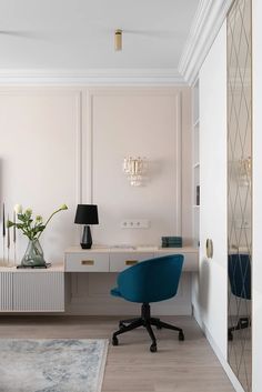 a blue chair sitting in front of a white desk