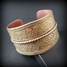 Vintage wide brass bracelet, chunky bracelet, Wide open wrist bangle bracelet, Handmade Copper & Brass Bracelet Ethnic Geometric Design Metal -  bronze outside, copper inside Stone -   Size - 6 3/4'' , wide '' Mark -  Circa  before the 2000s  Condition - good condition.  PLEASE NOTE: Vintage jewelry can show signs of wear and discoloration or chipped metal consistent with age. Please look at the pictures carefully. Most were purchased at estate sales, auctions, etc. so they could need cleaning. Bohemian Antique Gold Bracelets For Gift, Handmade Bronze Bohemian Bracelets, Handmade Bronze Cuff Jewelry, Adjustable Bohemian Bracelet With Antique Finish, Handmade Antique Gold Bohemian Bracelets, Handmade Bohemian Bronze Bracelets, Bohemian Engraved Cuff Bracelet Bangle, Bohemian Engraved Bangle Cuff Bracelet, Bohemian Engraved Cuff Bangle