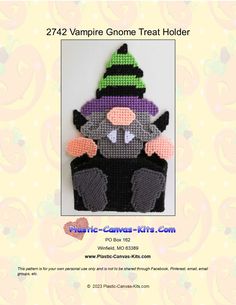 a crocheted stuffed animal wearing a witches hat