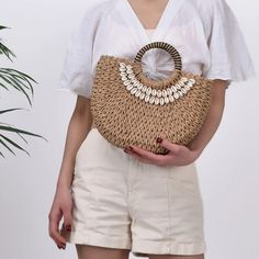 Embrace Elegance with the Perfect Summer Handbag Step into summer with our Medium Handmade Straw Woven Seashell Semi-Circular Beach Resort Crossbody Handbag. This stylish accessory effortlessly combines functionality and fashion, making it a must-have for any beach outing, resort vacation, or casual street fashion look. Crafted with care, this bag is designed to elevate your style while offering practical features that every modern woman needs. Product Features Dimensions: 30cm length, 9cm width, 20cm height Handle Length: 10cm, Shoulder Strap Length: 120cm Weight: 375g Material: High-quality polyester with a soft, flexible design Shape: Casual tote with a unique semi-circular silhouette Closure: Secure string closure Interior: No pockets for a sleek, minimalist look Gender: Women Style: F Chic Beige Beach Bag For Summer, Elegant Natural Beach Bag For Beach Season, Elegant Natural Beach Bag For Vacation, Trendy Handheld Crochet Bag For Vacation, Elegant Natural Color Beach Bag For Vacation, Elegant Woven Beach Bag For Vacation, Elegant Woven Beach Bag, Chic Woven Shoulder Bag For Vacation, Elegant Straw Tote Bag For The Beach