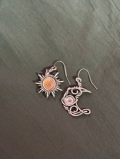 Enchant yourself or a loved one with these beautiful bohemian sun and moon drop earrings. The perfect gift for any lover of the stars!  These earrings are silver plated.  Jewellery care🔮 To ensure the longevity of this jewellery keep away from water for example showering or swimming etc.   Avoid harsh chemicals such as perfumes and sprays and remove jewellery before going to bed.  To clean jewellery just wipe with a soft cloth or ear bud. Summer Silver Alloy Earrings, Trendy Silver Jewelry With Moon Charm, Bohemian Sun And Moon Earrings For Festivals, Bohemian Sun And Moon Design Earrings For Festival, Summer Jewelry With Sun And Moon Design, Bohemian Summer Jewelry With Sun And Moon Design, Bohemian Sun And Moon Design Jewelry For Summer, Sun And Moon Design Jewelry For Summer, Sun And Moon Design Jewelry As Summer Gift