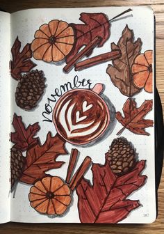 an open notebook with autumn leaves, acorns and coffee on the page that says november