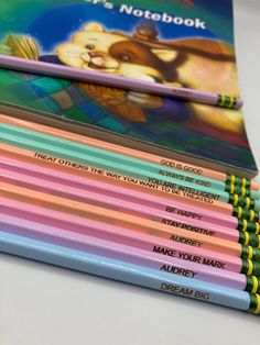 a stack of colored pencils sitting next to each other on top of a table