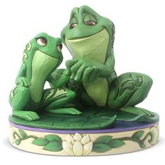 two green frogs sitting on top of each other