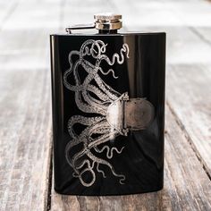 a black flask with an octopus on it