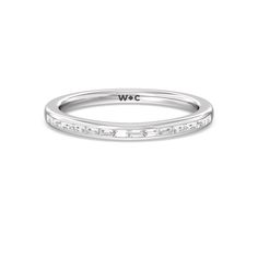 a white gold wedding band with princess cut diamonds on the outside and side stones at the top