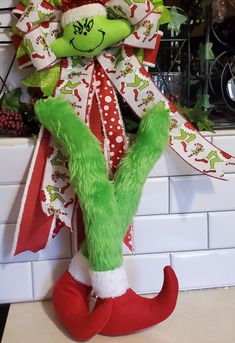 the grinch is hanging on the kitchen wall