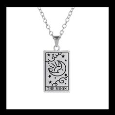 the moon tarot card pendant on a silver plated chain with an inscription that reads,