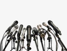 a bunch of microphones are lined up in front of each other on a white background