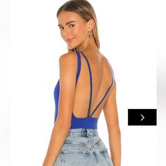 the back of a woman's bodysuit that is cut in half and has blue straps