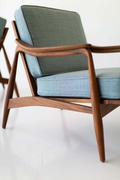 two chairs sitting next to each other on a white floor