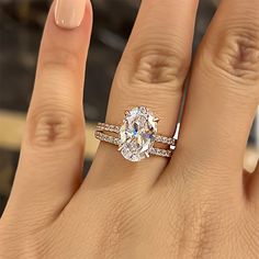 a woman's hand with a ring on it and a diamond in the middle