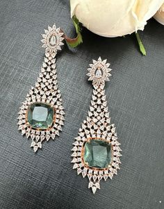 One of a kind Greenish stone rosegold diamond look earrings. The prasiolite look stone with cubic zirconia set in rosegold earrings. Premium quality product. Easy push back closure. ** P.S: non returnable product. Please ask any question if you have related to this product before purchasing as returns for size, color or weight etc are not covered. Buyer is responsible for return shipping cost in these cases. Luxury Rose Gold Earrings With Gemstone Accents, Formal Rose Gold Earrings With Gemstone Accents, Rose Gold Diamond Earrings With Gemstone, Elegant Rose Gold Earrings With Gemstone Accents, Elegant Green Earrings With Rose Cut Diamonds, Party Rose Gold Gemstone Earrings, Rose Gold Diamonds, P S, Bridal Jewelry