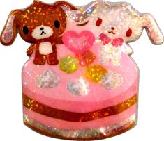 two stuffed animals sitting on top of a pink cake covered in sequins and glitter