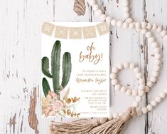 a baby shower card with a cactus and flowers on it next to a tassel