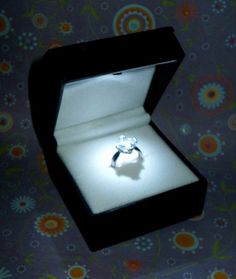 an open box with a ring in it