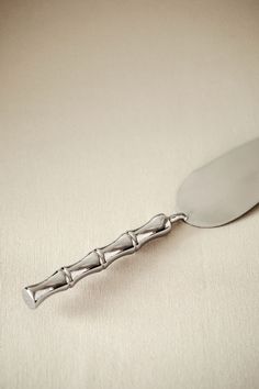 a silver spoon sitting on top of a table