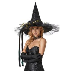 a woman wearing a witches hat and gloves with her hands on her hips, posing for the camera