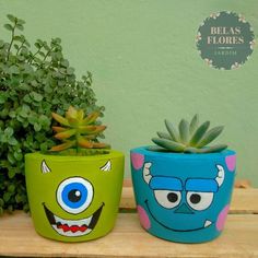 two planters with plants in them sitting on a wooden shelf next to each other