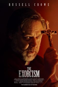 the exorcism movie poster with a man holding a cross in his hand