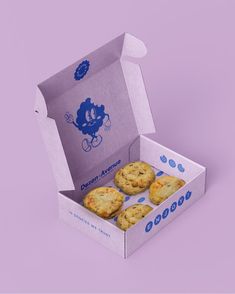 an open box of cookies on a purple background