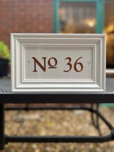 a white framed sign sitting on top of a table