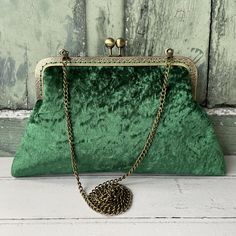 Beautiful jewel green velvet 8 inch clasp vintage style purse frame clutch bag hand sewn into a highly decorative engraved antique bronze purse frame. The chain strap is long enough to wear across your body or as a shoulder bag. - handmade by Girl Got Bag - made on order - velvet exterior fully interfaced with fusible cotton and wadding for support - satin lining - bag loops fixed on top of frame for purse chain shoulder strap  - clutch size height: 15cm | 6 inches and width: 25cm | 10 inches (a Vintage Green Formal Clutch, Green Evening Bag With Chain Strap, Elegant Green Evening Bag With Chain Strap, Green Clutch With Chain Strap For Formal Occasions, Green Formal Clutch With Chain Strap, Formal Green Clutch With Chain Strap, Formal Green Handmade Clutch, Vintage Green Clutch For Everyday Use, Purse Frame