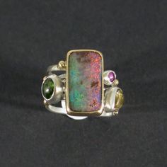 Tourmaline & opal swirled gold silver ring, Four stone band ring Multicolor Opal Multi-stone Rings, Unique Opal Rings With Gemstone Accents, Unique Multicolor Opal Gemstone Ring, Unique Multicolor Cabochon Opal Ring, Unique Multi-stone Opal Rings, Unique Opal Ring With Gemstone Accents, Cabochon Rings, Boulder Opal Jewelry, Modern Rings