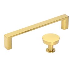 an image of two handles and knobs in brass finish on a white background with copy space