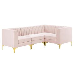 a pink sectional sofa with gold legs