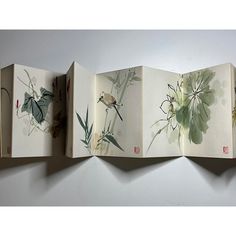 an open book with flowers and birds on it