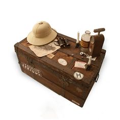 an old trunk with various items on it including a hat, scissors and other things